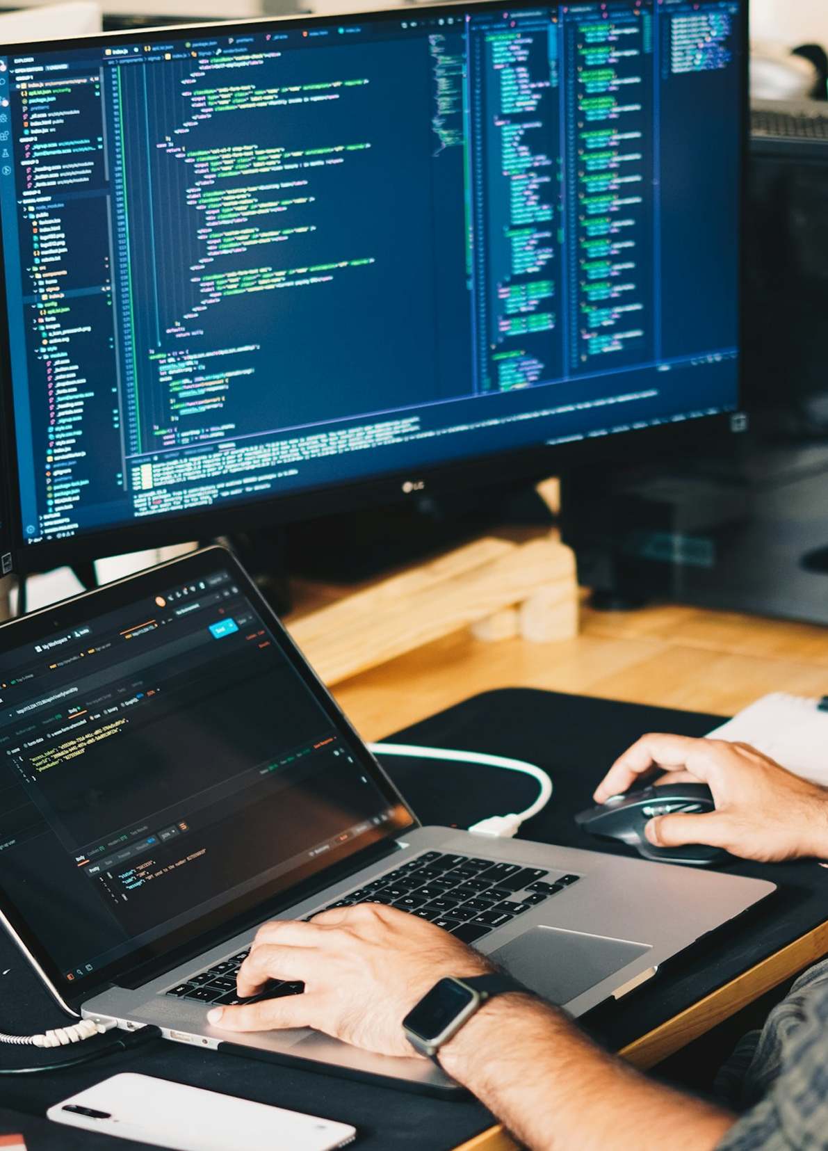 Developer workspace with custom software development on multiple monitors